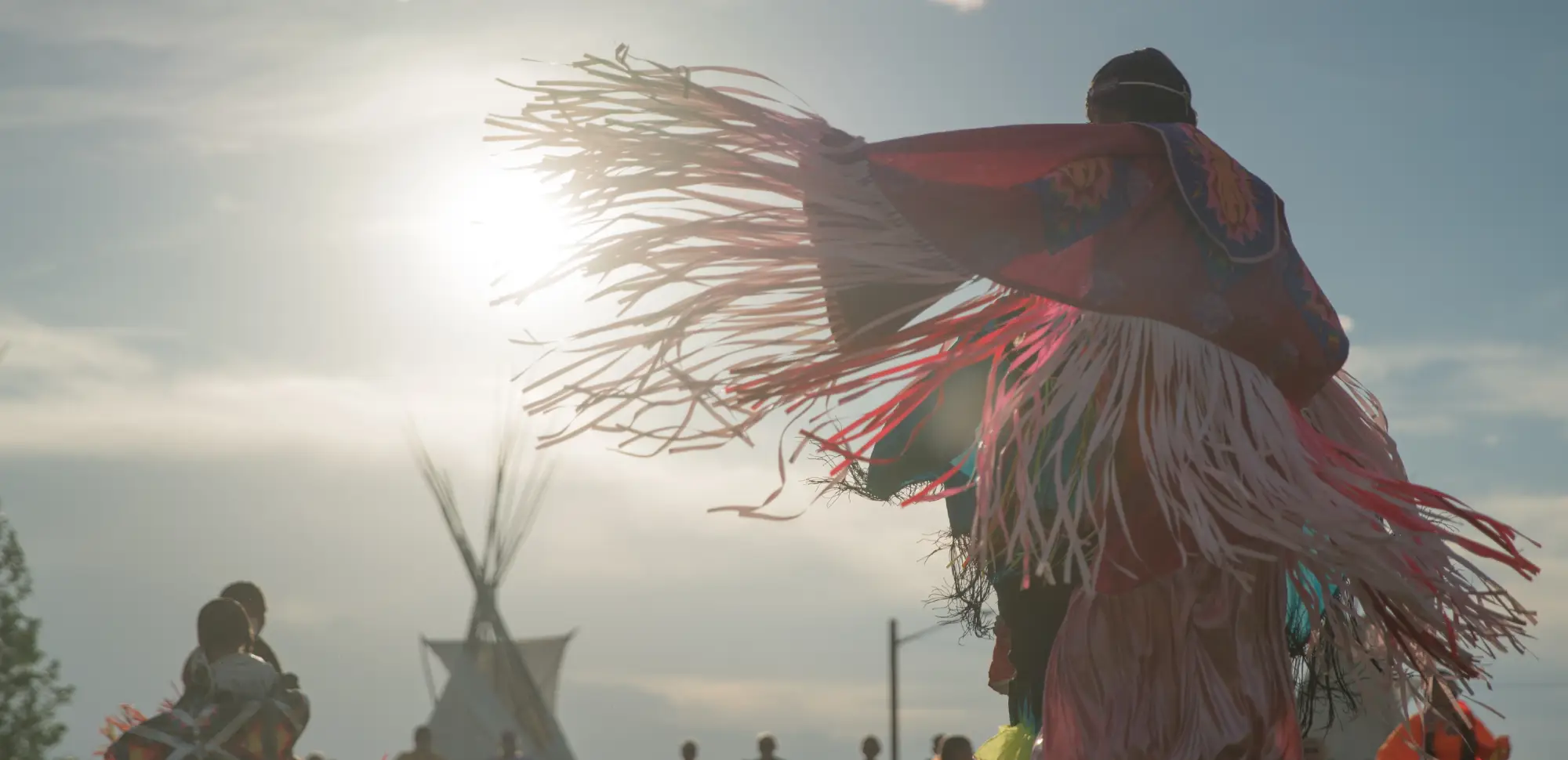 Ceremonial dance in a landscape at sunset